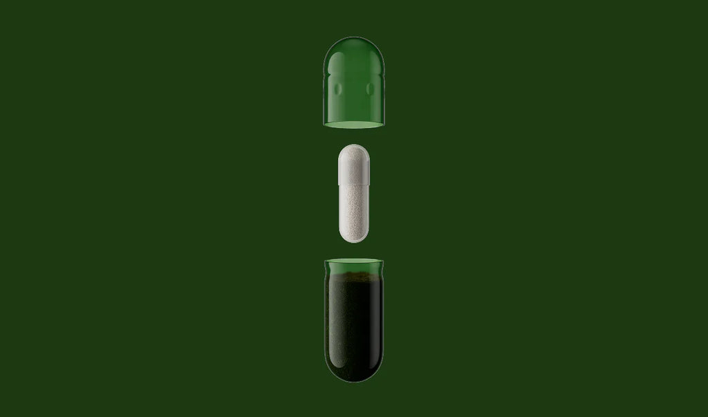 Three capsules with different contents on a green background